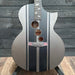 Acoustic guitar with black and silver design on a wooden background